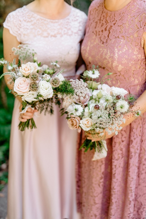 Bridesmaids with beautiful bouquets in elegant, lace dresses