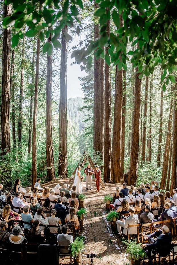 Wedding ceremony taking place in a beautiful forest setting