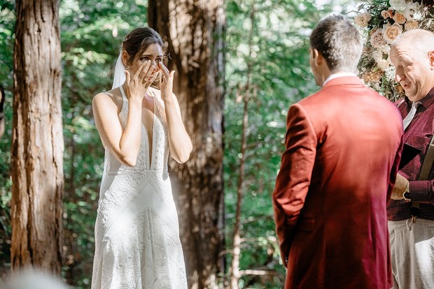 Tearful bride reacting to the groom during an outdoor wedding ceremony