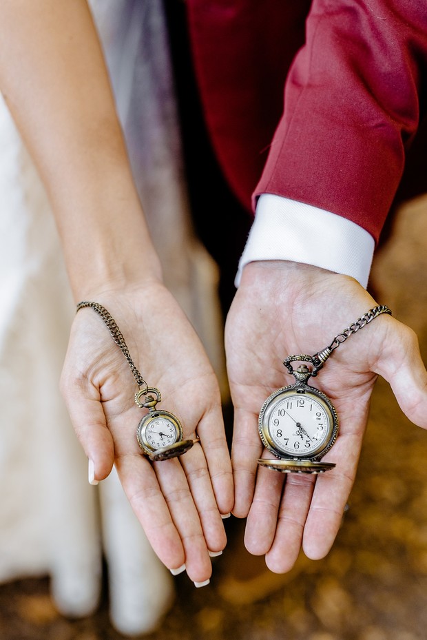 Wedding hands holding pocket watches symbolizing timeless love