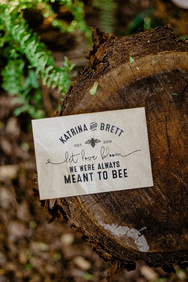Wedding invitation with bee themed quote on wood stump
