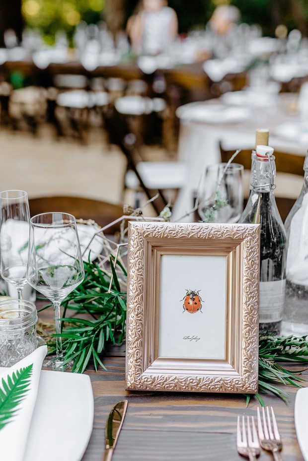 Elegant table setting with a ladybug picture frame decoration
