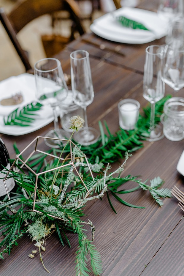 Elegant wedding table setting with geometric decor and greenery