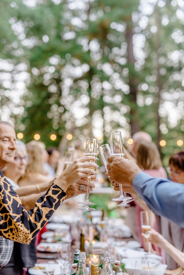 People toasting champagne flutes at an outdoor celebration