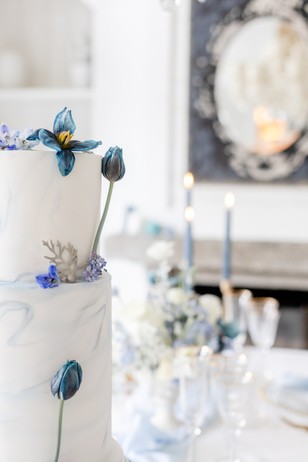 blue floral topped wedding cake