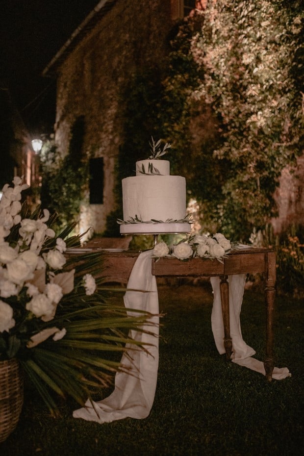 wedding cake topped with olive branches