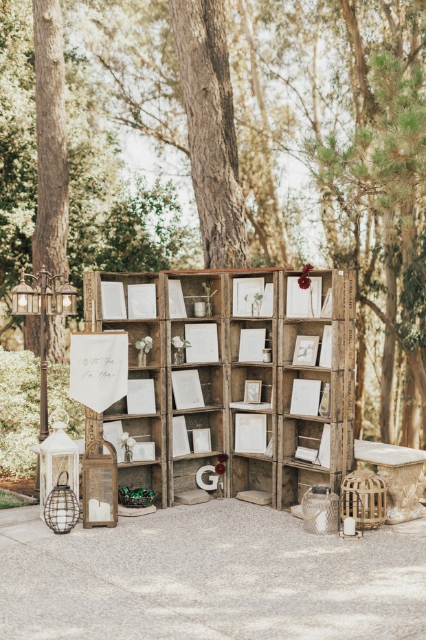 Rustic wedding display with seating chart, lanterns, and decor