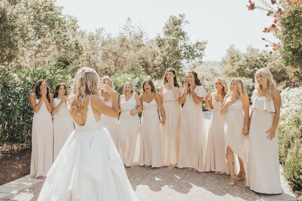 Bride reveals herself to bridesmaids, joyful wedding day moment