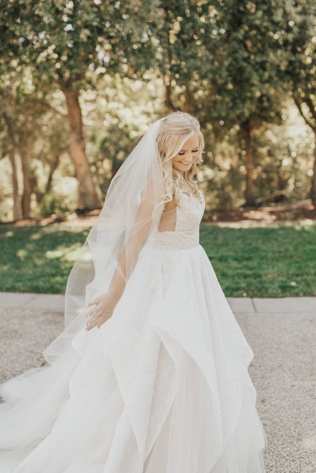 Beautiful bride in a white wedding dress, smiling outdoors