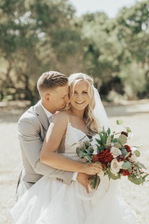Happy bride and groom embrace on their wedding day