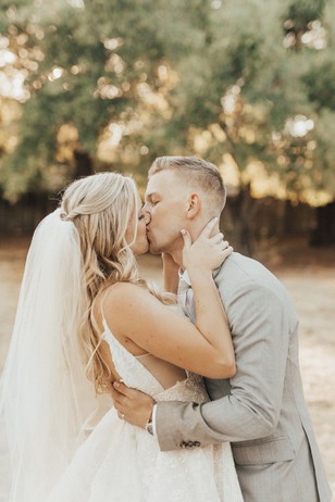 Bride and groom share a tender kiss at their wedding ceremony