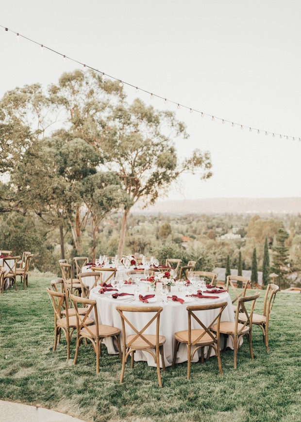 Outdoor wedding reception table setting on green lawn