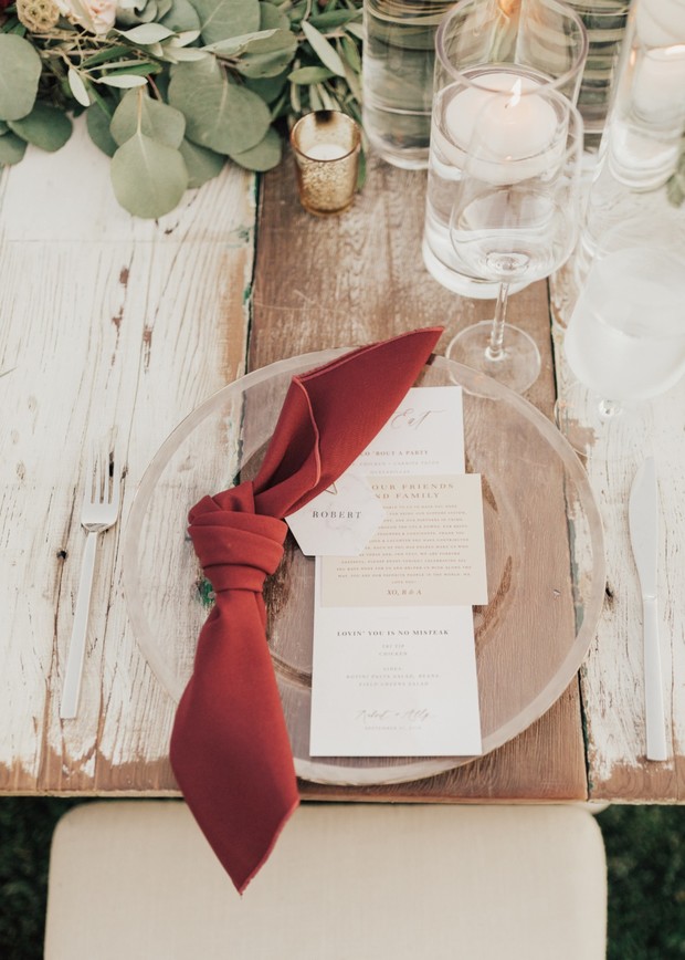Elegant wedding table setting with red napkin and menu