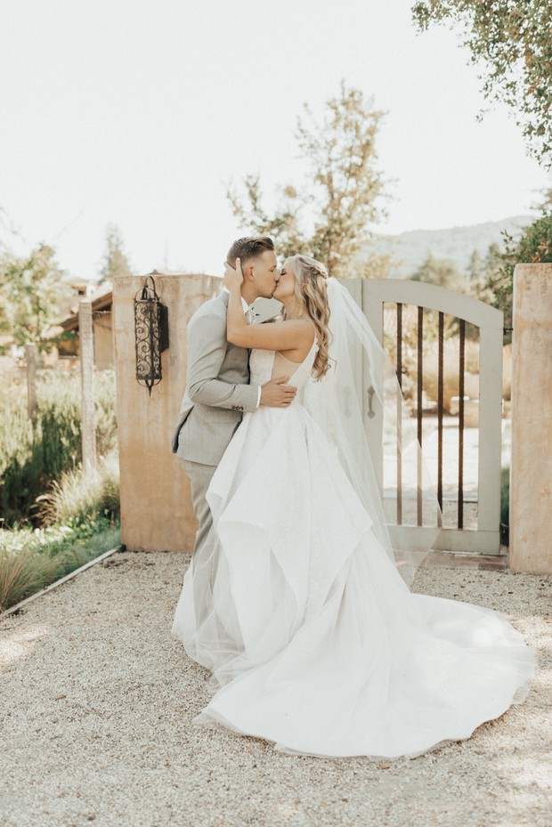 Happy couple sharing a kiss on their wedding day at venue