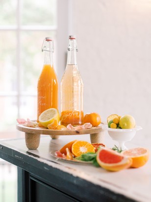 Fresh citrus fruits and juices on a kitchen counter