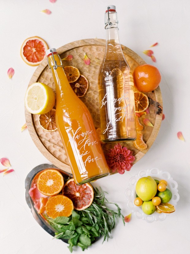 Citrus fruit infused drink bottles on decorative plates