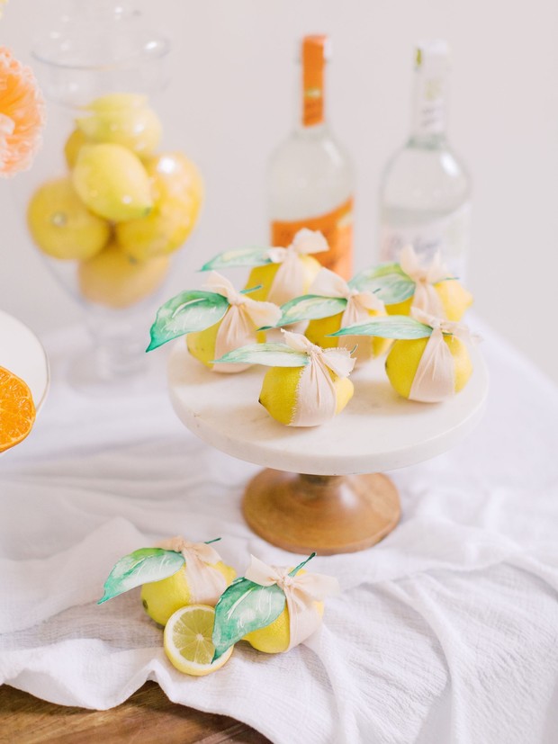 Lemons with ribbons on cake stand, citrus party decor
