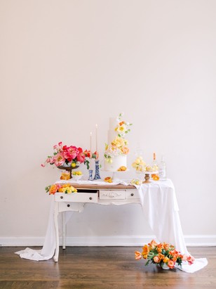Elegant dessert table with flowers, cake and candles