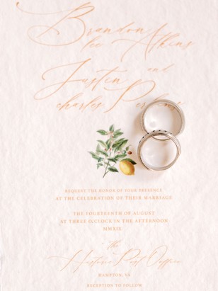 Elegant wedding invitation with rings and citrus detail