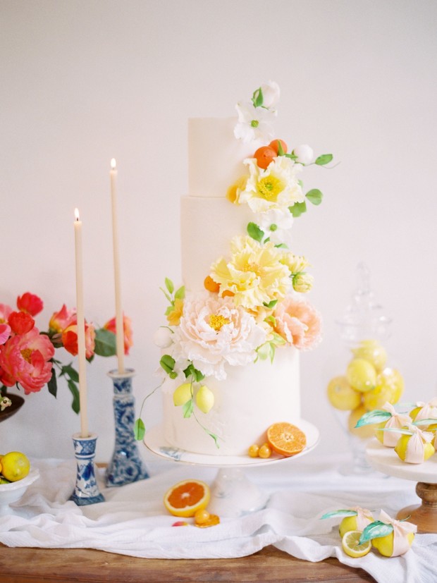 Elegant wedding cake decorated with floral and citrus accents