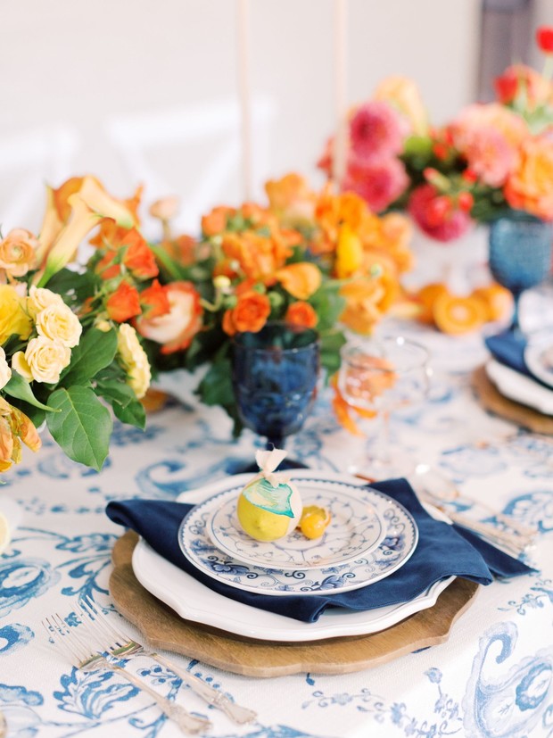 Elegant table setting with blue and orange floral decorations