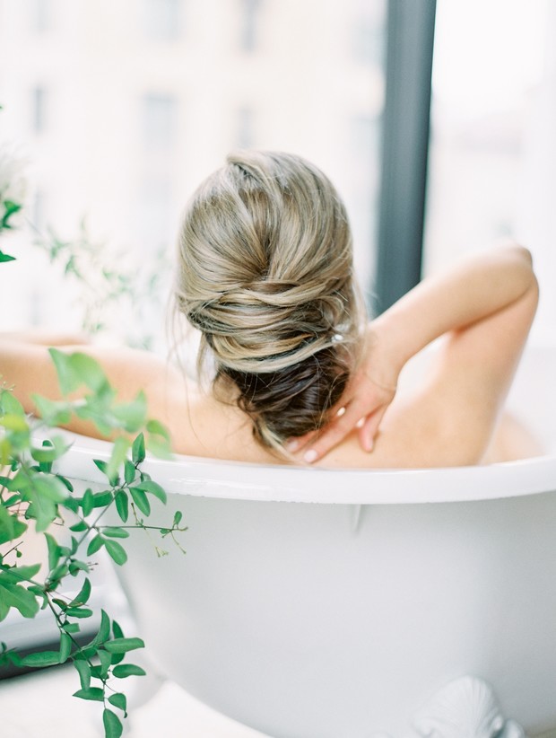 Woman relaxing in a luxurious bath with elegant updo