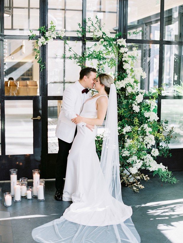Bride and groom share a kiss, elegant wedding ceremony