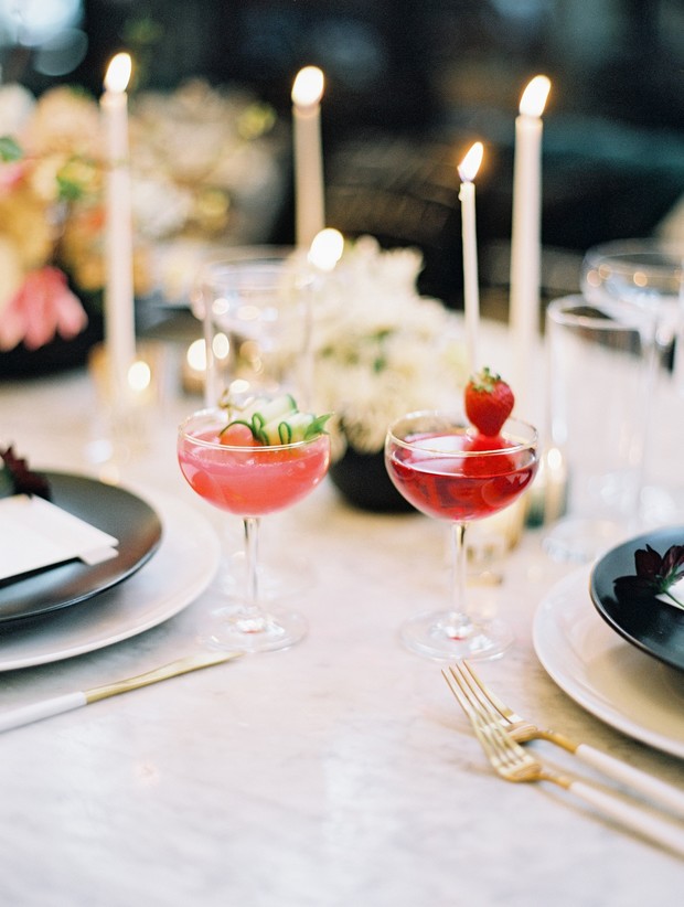 Elegant pink cocktails garnished with fruit, ready for a romantic dinner