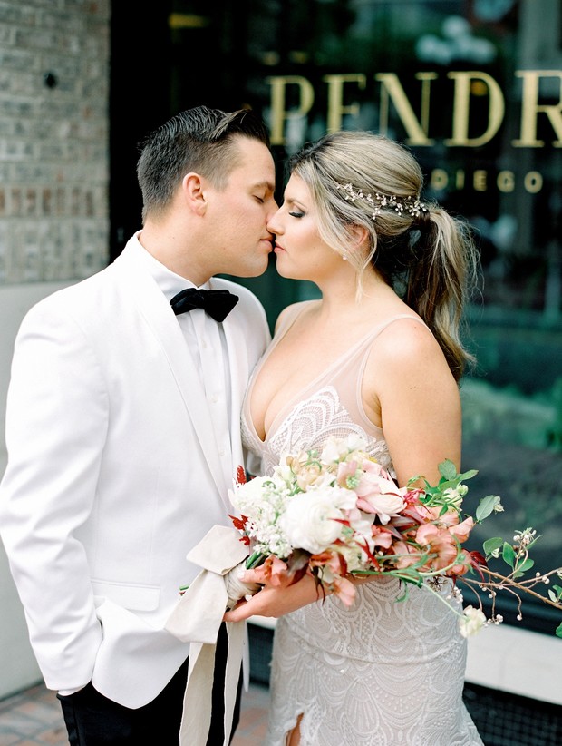 Bride and groom sharing a tender kiss at their wedding