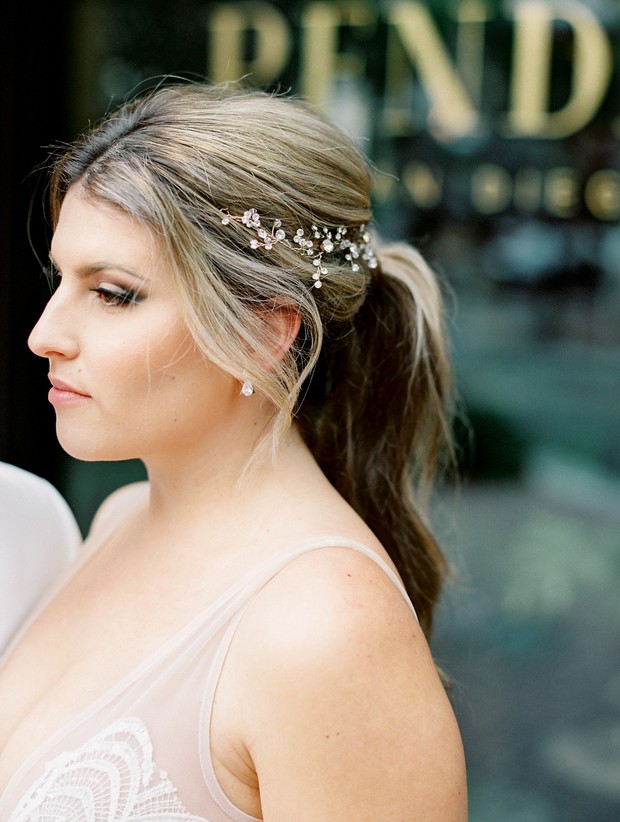 Elegant bride with a jeweled hairpiece in a side profile portrait