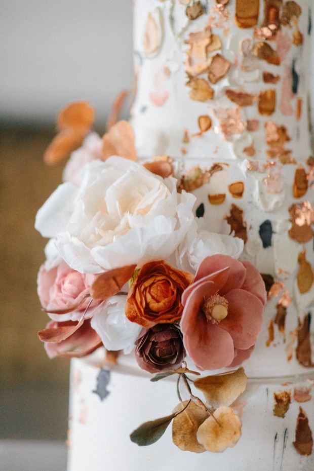 copper and gold wedding cake with fresh florals