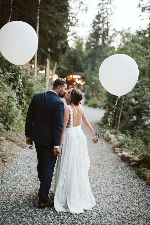 bride and groom with giant balloons