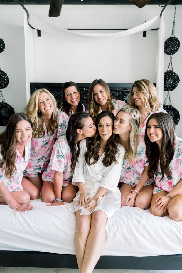Bride and bridesmaids in floral robes, happy smiles