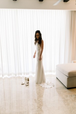 Elegant bride in white dress preparing for her wedding day