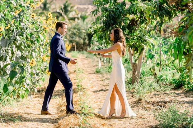 Groom walking to bride in an outdoor wedding setting