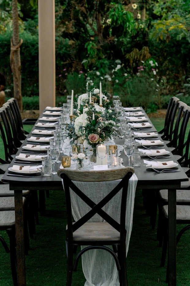 Elegant outdoor wedding table setting with floral centerpiece