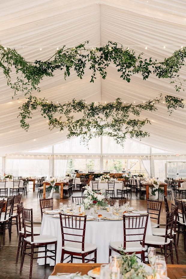 chic tent wedding venue with hanging greenery