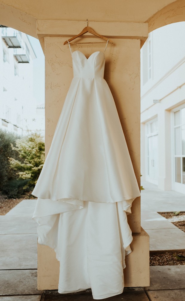 Elegant white wedding dress hangs ready for the big day