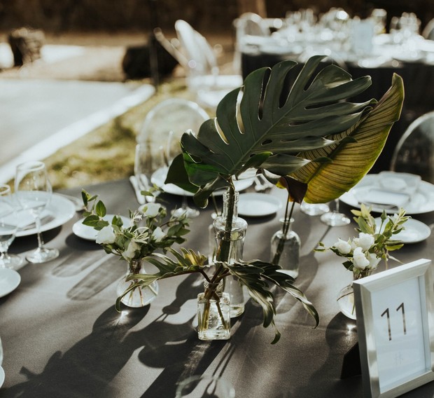 Wedding table setting with floral centerpiece and number 11 card