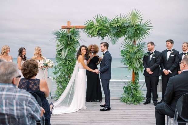 Bride and groom exchange vows at outdoor wedding ceremony