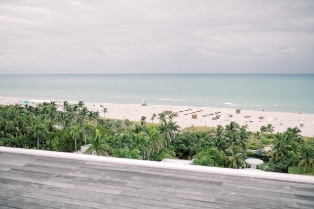 Serene ocean view from a rooftop deck overlooking a tropical beach