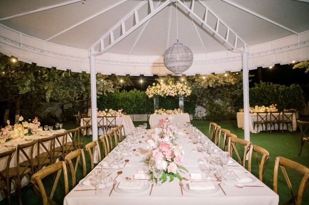 Elegant outdoor wedding reception setup with floral centerpieces