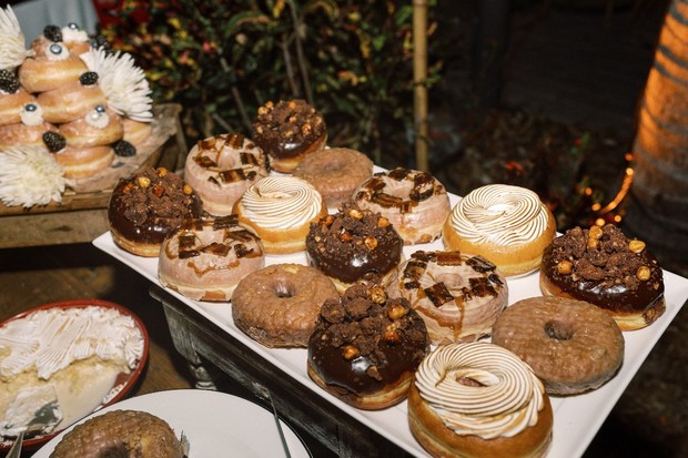 A delectable assortment of gourmet donuts on a party table display