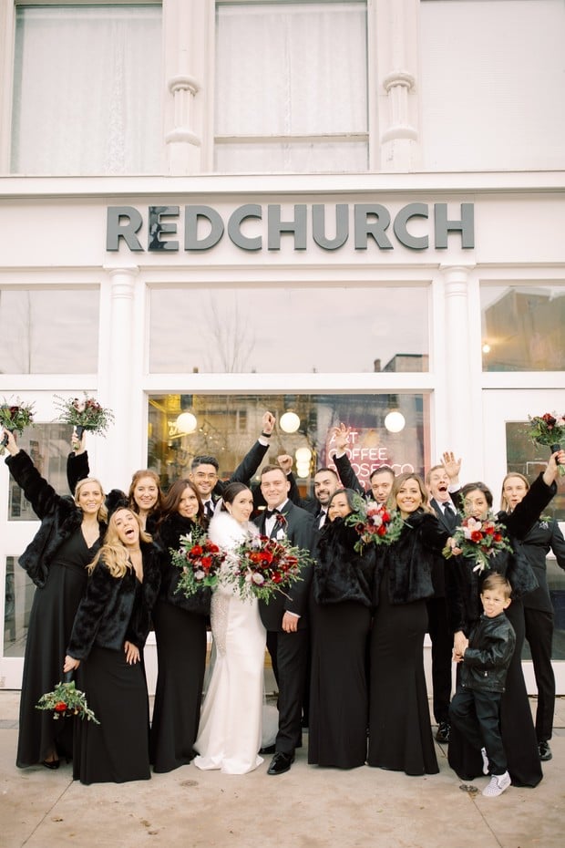 bridal party in black dresses and fur