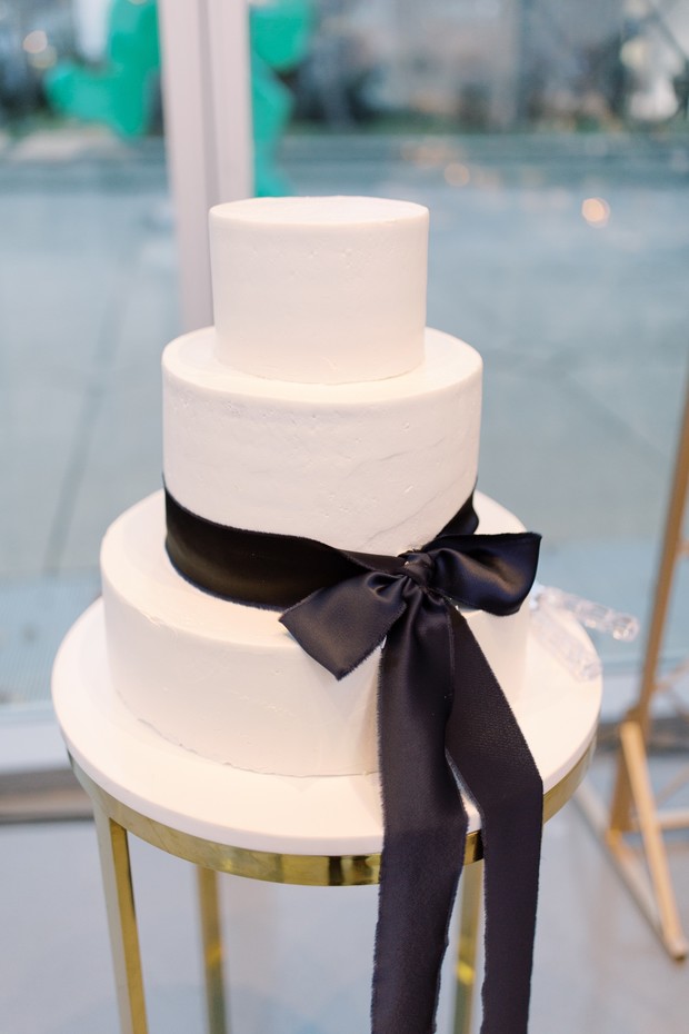 white wedding cake with black bow