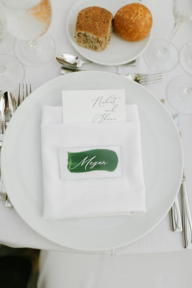 simple and chic wedding place setting in white and green