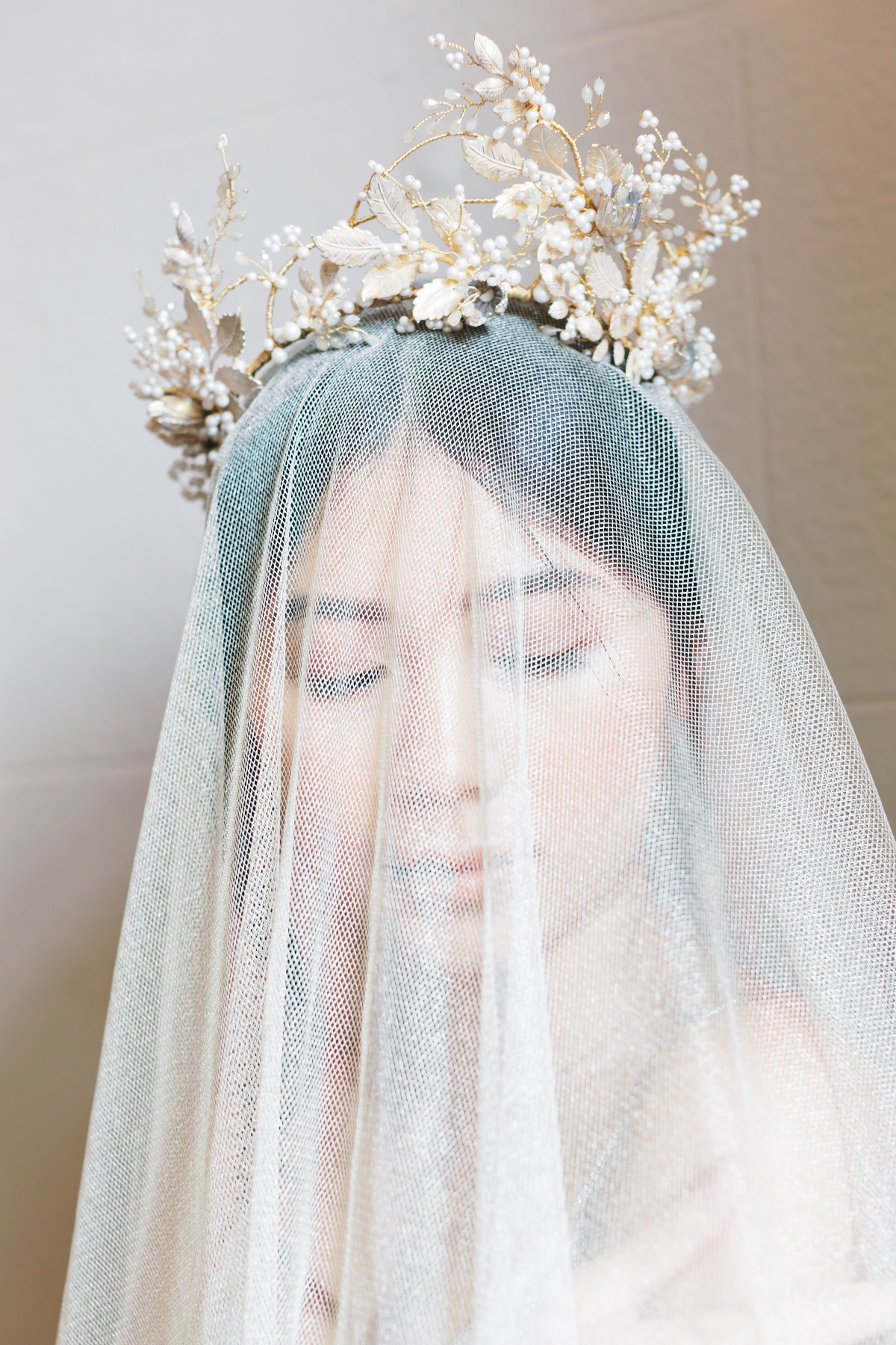 Bridal portrait of a woman wearing a veil and crown