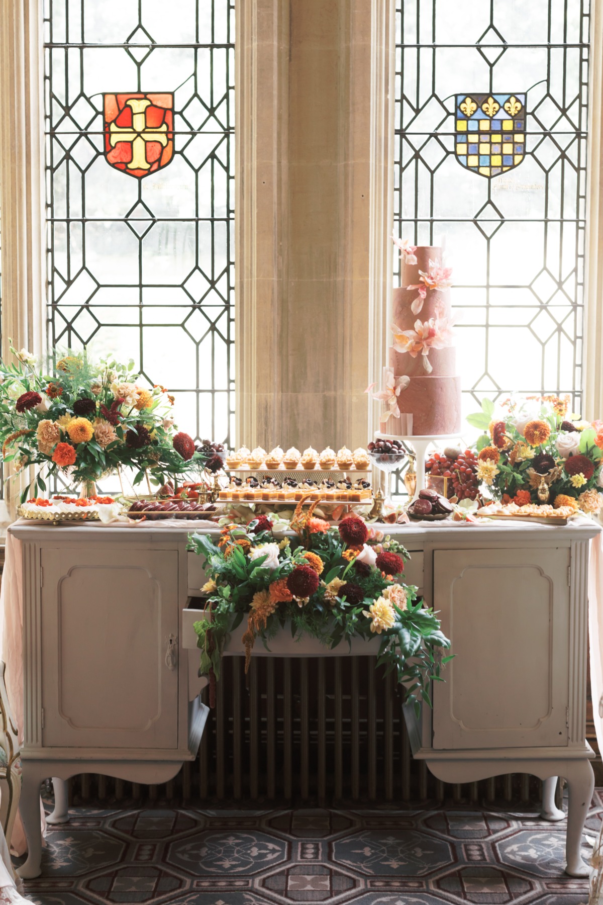 Elegant wedding dessert table with cake and floral decorations