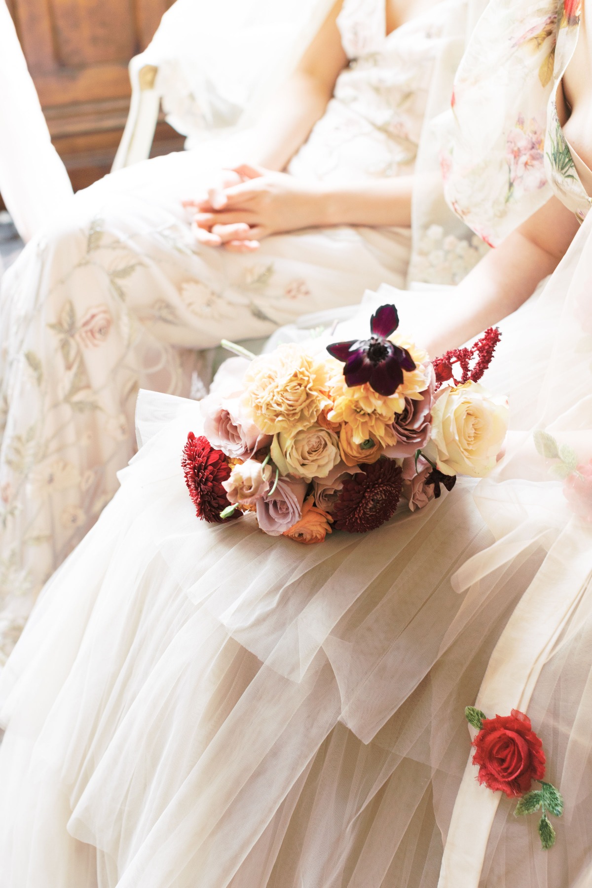 Bridal bouquet on a layered tulle dress at wedding