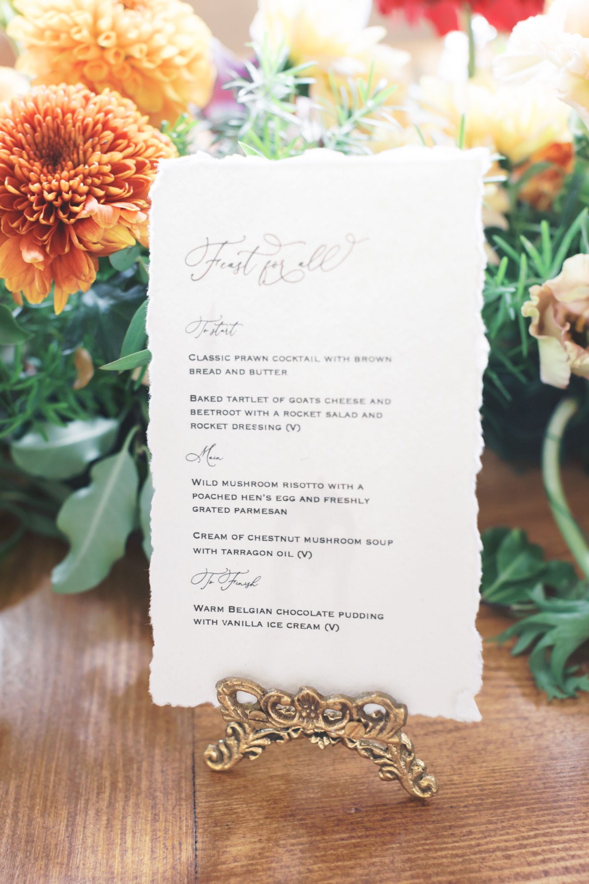 Elegant wedding menu card with floral background and golden stand